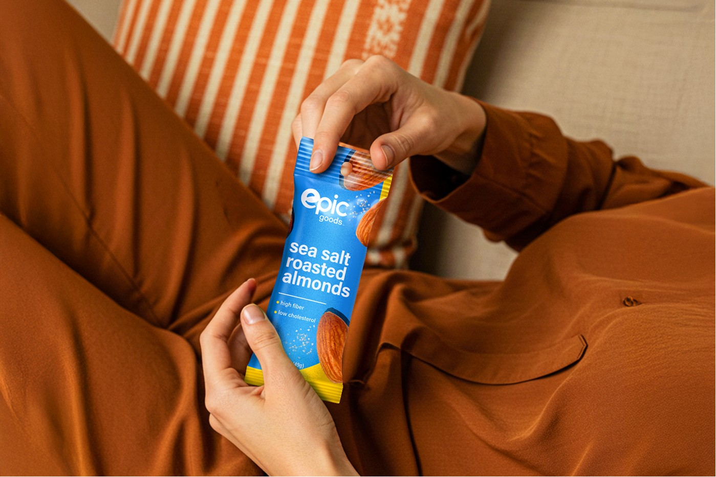 People sharing Epic Goods snacks and beverages on a couch