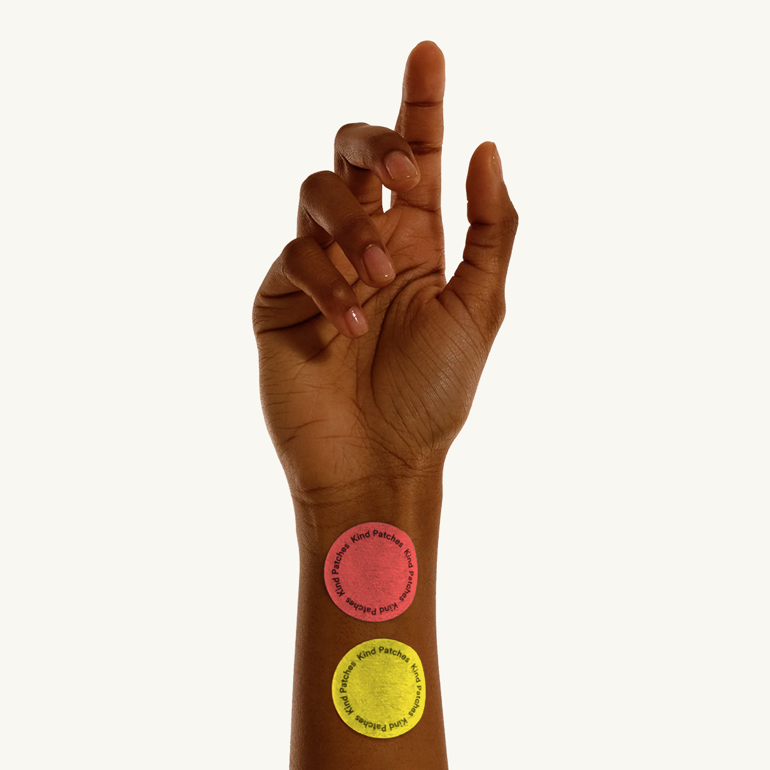 Kind Patches Happy Love bundle frame with red and yellow patches on a raised wrist