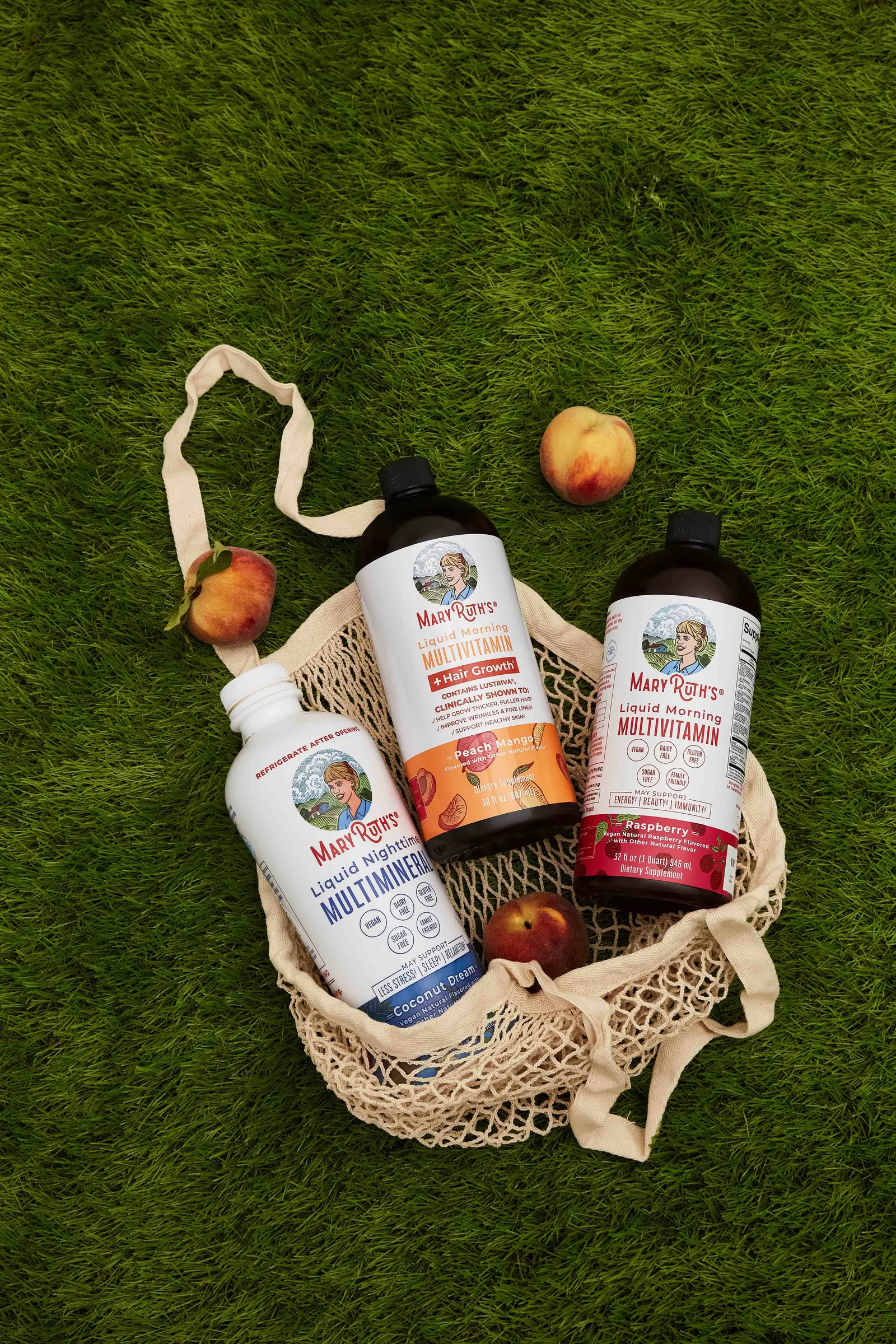 MaryRuth’s liquid bottles in a mesh tote on grass